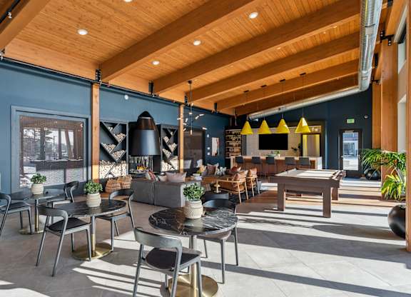 A modern cafe with wooden tables and chairs.