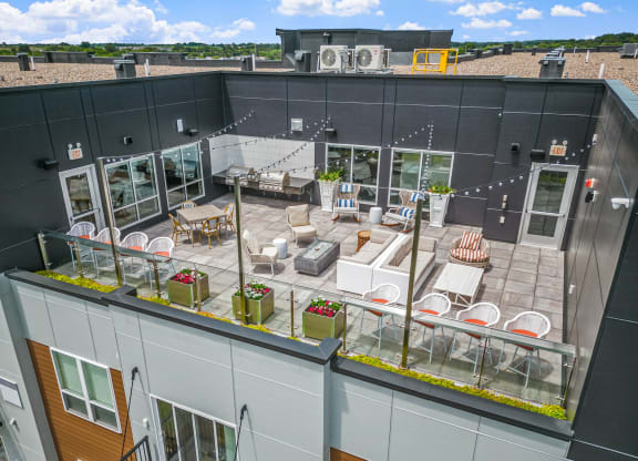 an aerial view of a rooftop patio with tables and chairs