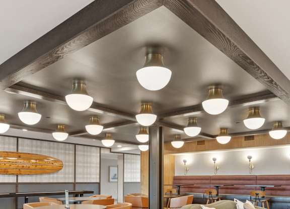 A modern dining area with a surfboard on the wall.