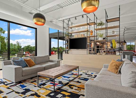 A modern living room with a grey sofa and a wooden coffee table.