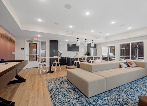 a living room with a couch and a table with chairs