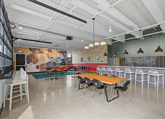 A modern meeting room with a long table and chairs.