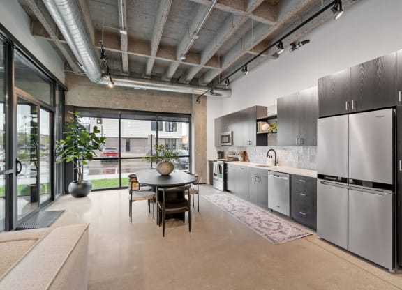 a kitchen with stainless steel appliances and a dining table
