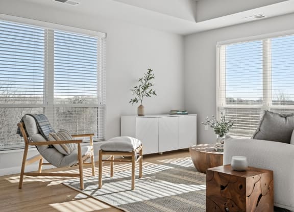 a living room with a couch and chairs and a table