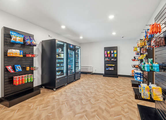 A row of black vending machines are lined up against a wall.