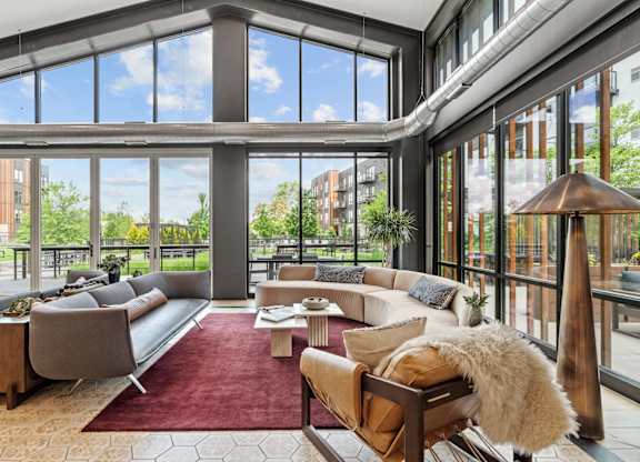 A large, modern living room with a view of the outdoors.