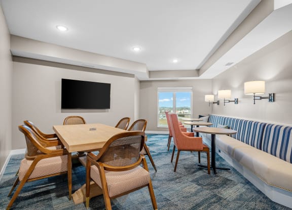 a living room with a table and chairs and a couch