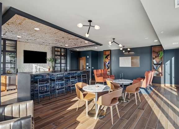 A modern dining area with a bar and a television.