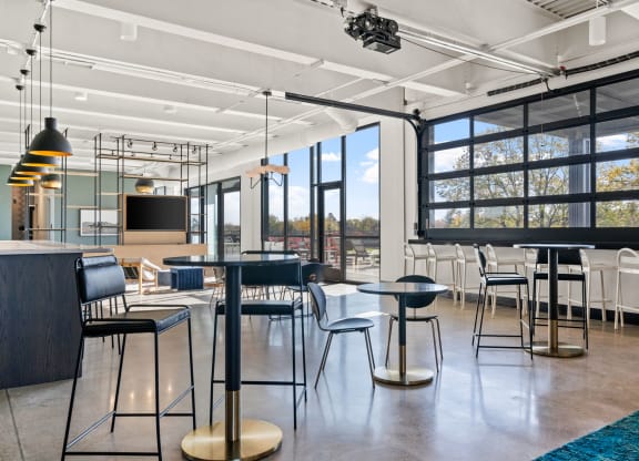 a large room with tables and chairs and a large window