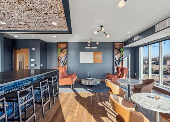 A modern bar area with a pool table and comfortable seating.