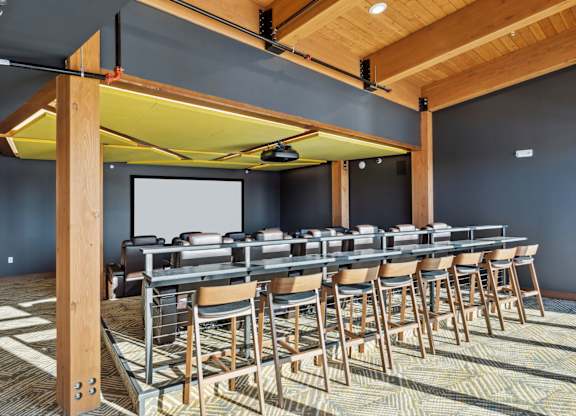 A conference room with a long table and chairs.