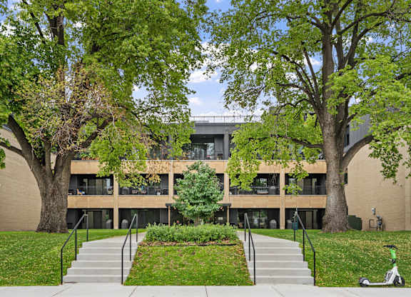 A modern building with a green lawn in front.