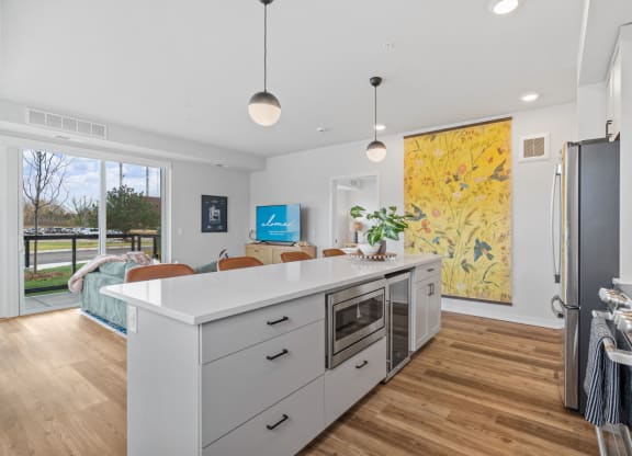 a kitchen with a white counter top and a refrigerator