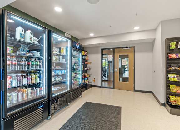 A row of refrigerators are lined up in a room.