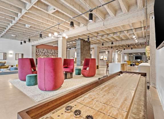A room with a shag carpet and a long table with a shag carpet runner.