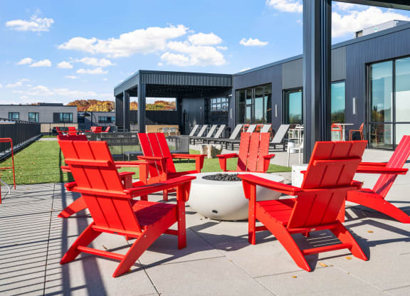 a group of red chairs outside of a building