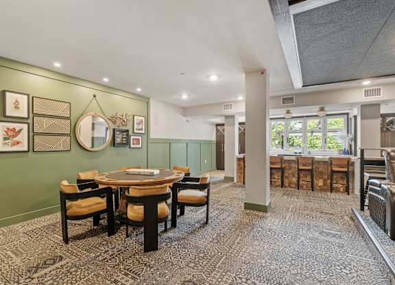 A dining room with a table set for six.