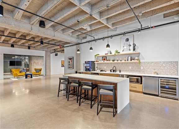 A kitchen with a bar area and a dining table.