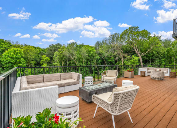 a deck with a couch and chairs and a table on it