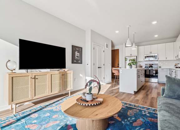 A living room with a television, a coffee table, and a couch.