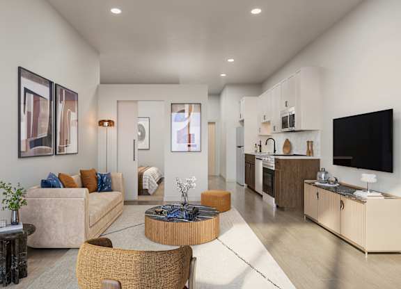 A modern living room with a sofa, coffee table, and television.