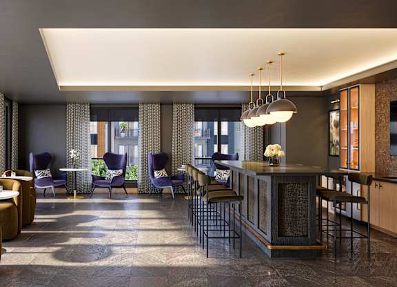 A modern living room with a bar area and comfortable seating.