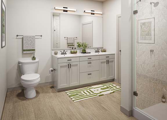A white toilet sits in a bathroom next to a sink and mirror.