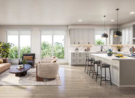 A modern kitchen with a large island and bar stools.