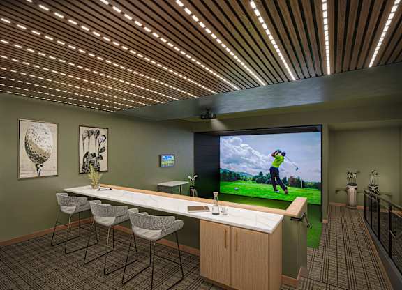A room with a long table and chairs, a television, and a golf simulator.