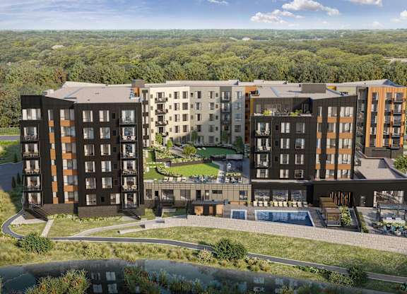 A modern apartment complex with a large courtyard and a swimming pool.