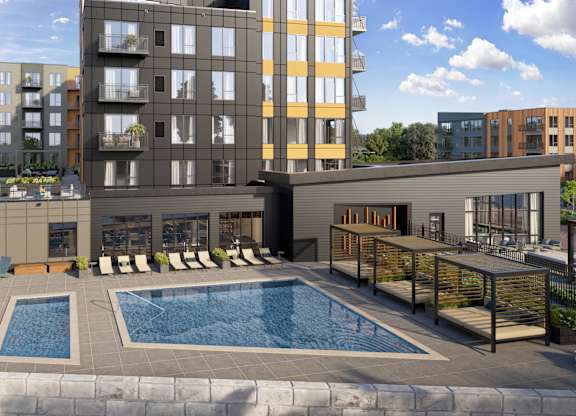 A modern apartment complex with a pool in the foreground.