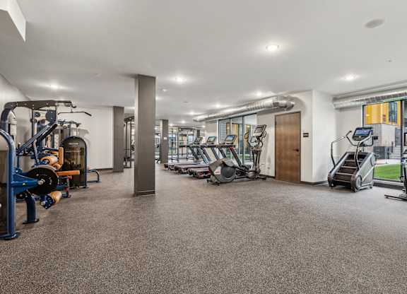 A spacious gym with various exercise equipment.