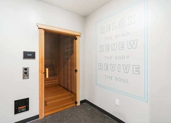 A room with a quote on the wall and a wooden door.