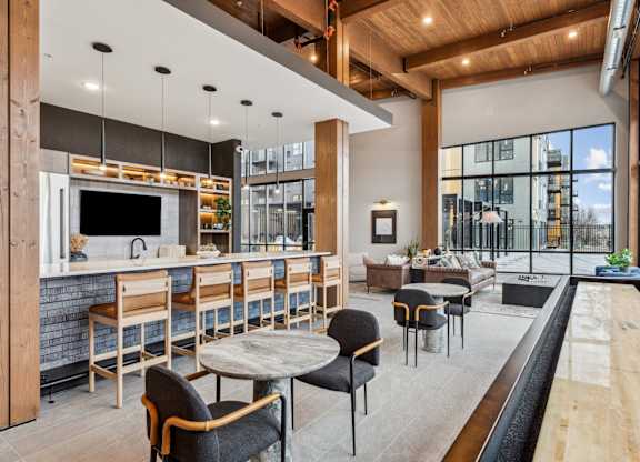 A modern kitchen and dining area with a bar and seating.