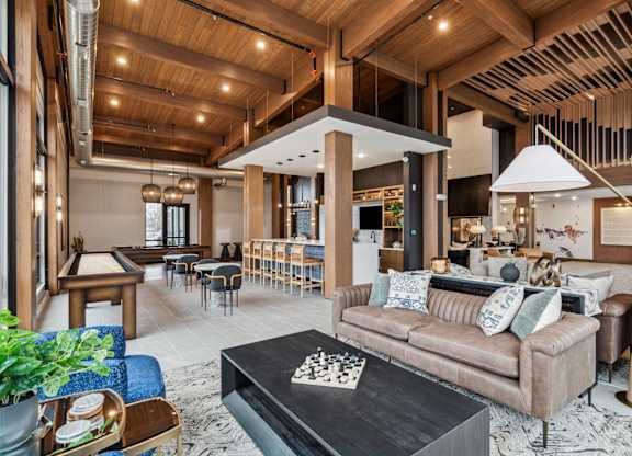A living room with a brown couch and a black coffee table.