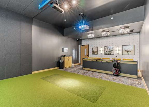 A room with a green floor and grey walls.