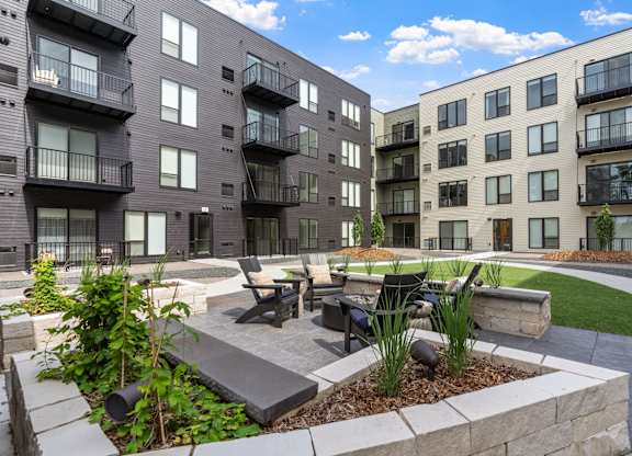 A modern apartment complex with a landscaped courtyard.