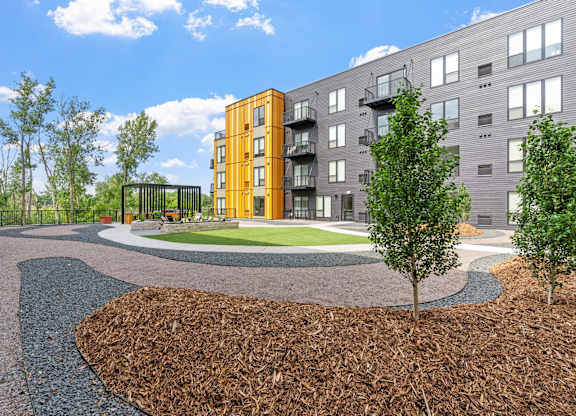 A modern apartment complex with a landscaped courtyard.