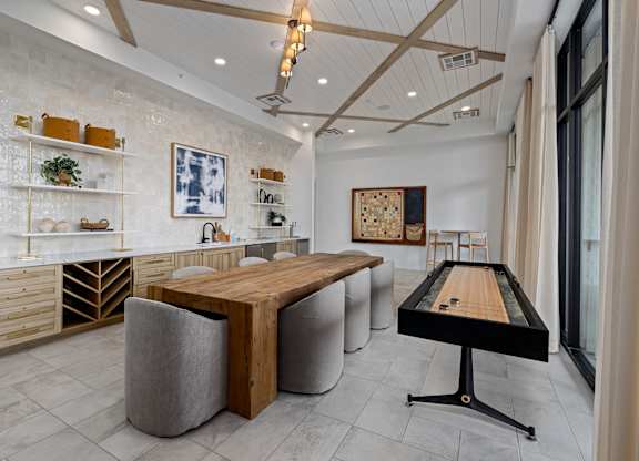 A room with a pool table and a shelf with various items on it.