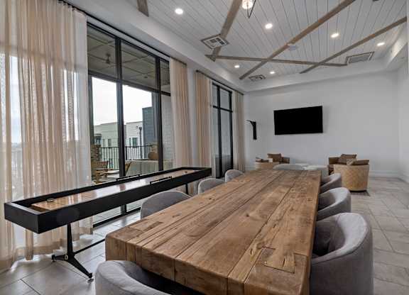 A conference room with a long wooden table and chairs.