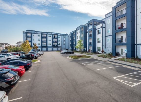 an empty parking lot in front of an apartment building