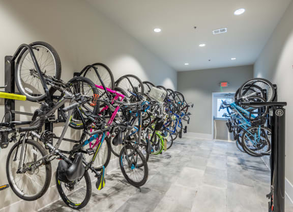 a row of bikes parked on a rack in a building
