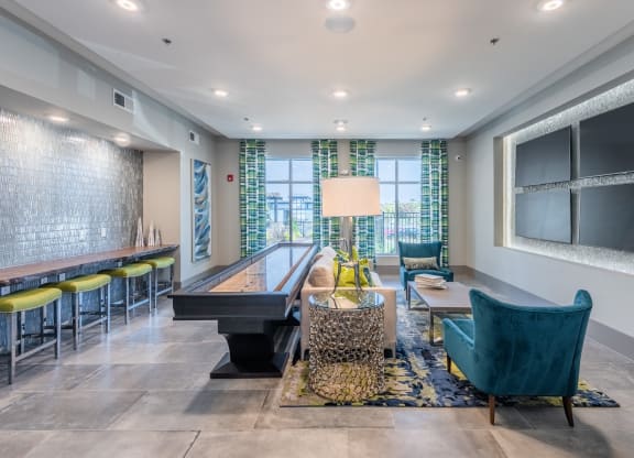 a living room with a piano and a table with chairs