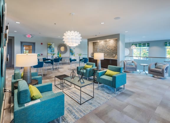 a lobby with blue couches and chairs and a bar