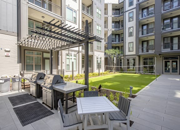 courtyard with grilling station and volleyball net