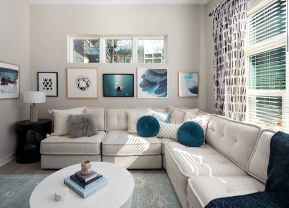 A living room with a white couch and a coffee table.