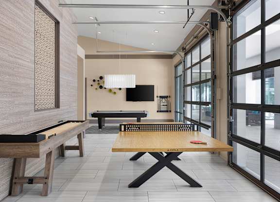 A room with a pool table and a tv.
