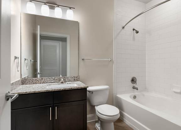 A white bathroom with a sink, toilet, and bathtub.