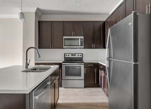 A modern kitchen with a stainless steel refrigerator.