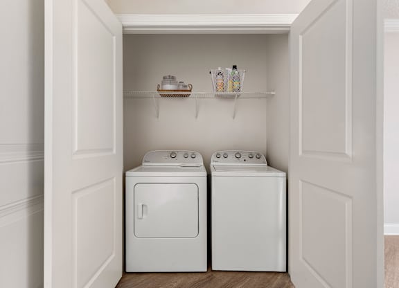 A small laundry room with a washer and dryer.